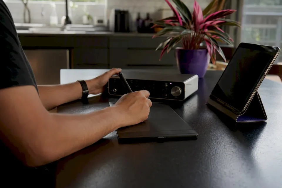 Hands interacting with digital audio workspace