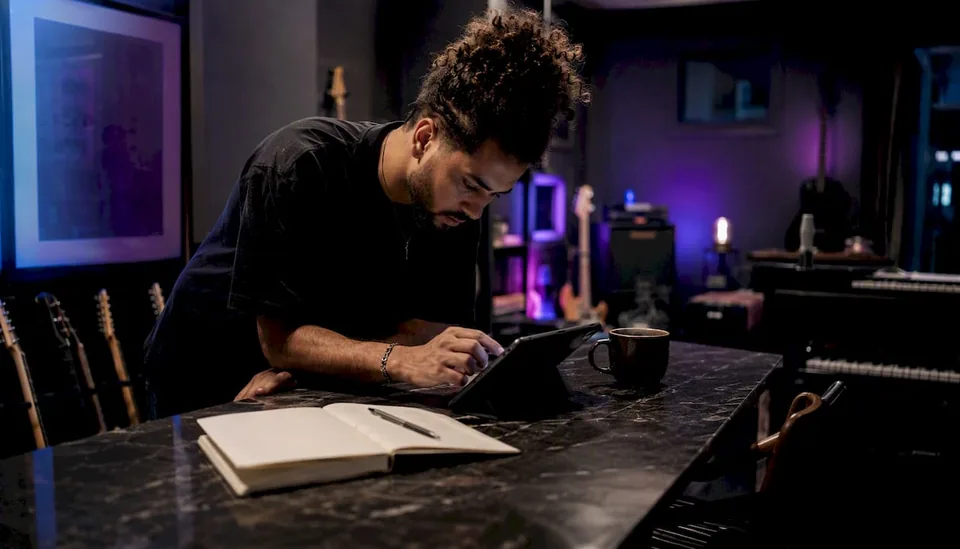 Musician preparing playlist submissions at desk