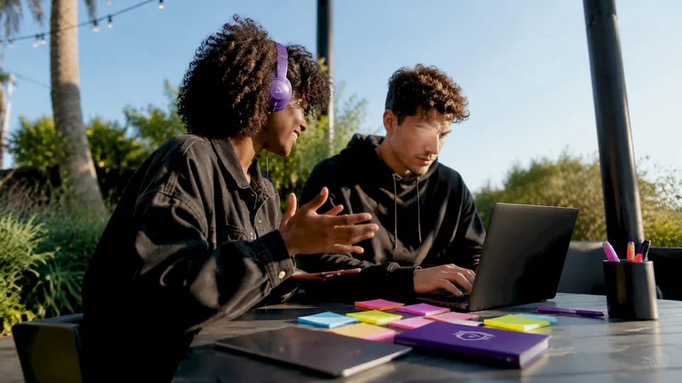 Hands typing on laptop for Spotify algorithm