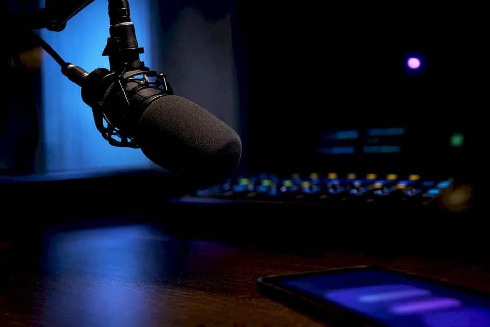Broadcast microphone beside anonymous playlist device