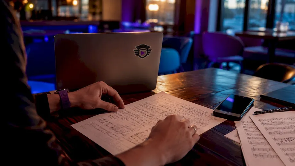 Close-up of hands typing playlist pitch email