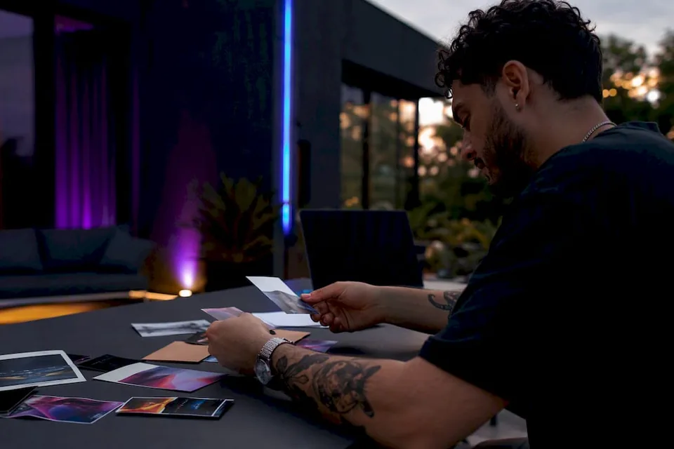 Hands sorting music promo cards in dark studio
